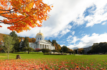 The Vermont State House with Colorful Foliage in Background.  Located in Montpelier, the house is...