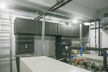 House heating system with many pipes, metal tubes and automated control equipment.