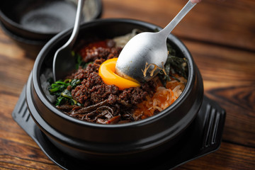 mixing korean famouse hot stone bowl bibimbap
