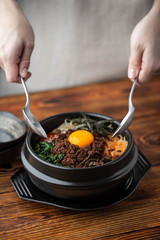 mixing korean famouse hot stone bowl bibimbap