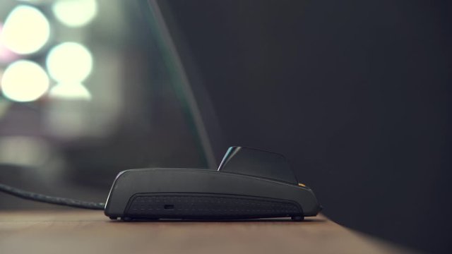 Contactless payment method. The girl applies the credit card to the banking terminal. Female customers using the credit card to pay for goods.