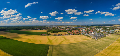 Aerial view from drone over yellow fields with a german city in background
