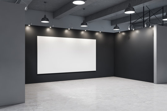 Minimalistic gallery interior with empty poster on black wall.