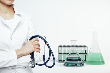 Woman doctor with stethescope and test tubes
