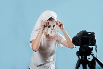 Littlr girl in towel on her head filming the video for her followers about clay facial mask ....