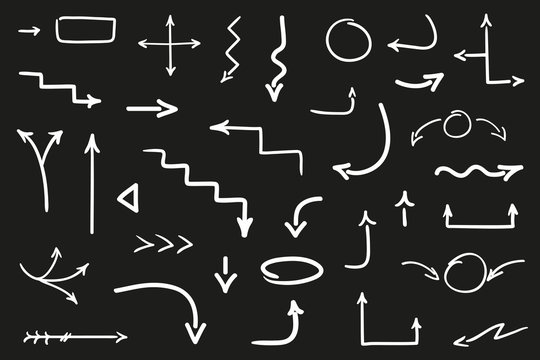 Hand drawn arrow on black. Set of different abstract arrows. Black and white illustration