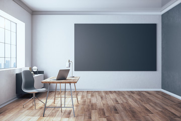 Stylish workspace with laptop and black poster