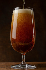 Beer pouring into a glass on the rust