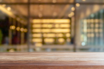 Empty wood table top and blurred coffee shop and restaurant interior space background - can used for display or montage your products.
