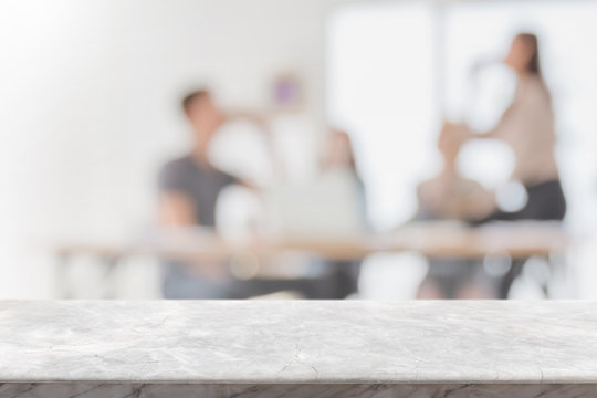 Empty white marble stone tabletop and blurred bokeh people working in office interior space banner background - can used for display or montage your products.