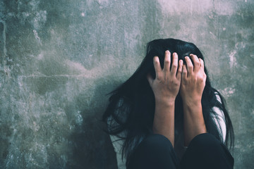 Depressed young crying woman - victim of domestic violence and abuse.