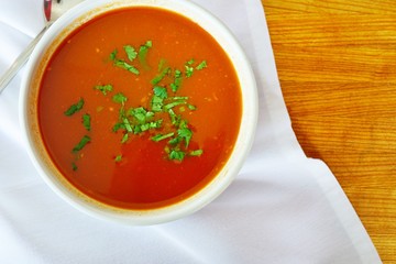 A bowl of tomato vegetable soup at an Indian restaurant