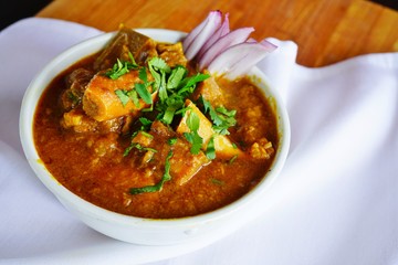 A dish of rogan josh red goat curry at an Indian restaurant