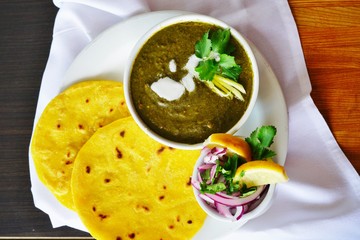 A dish of sarson ka saag spinach stew at an Indian restaurant - obrazy, fototapety, plakaty