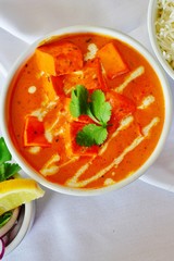 A dish of paneer makani tikka masala in red sauce at an