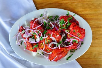 A dish of grilled chicken tandoori at an Indian restaurant - obrazy, fototapety, plakaty