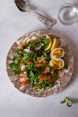 Salmon egg radish and lamb leaves salad. Healthy diet food. View from above, top view