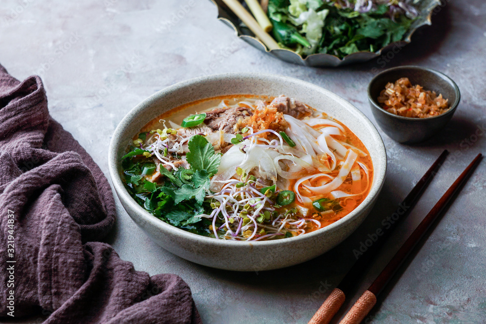 Wall mural bun bo hue, bun bo, vietnamese beef noodle soup spicy. bowl of beef and rice vermicelli soup, vietna