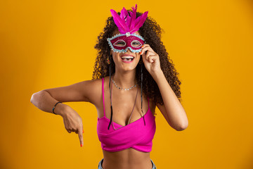 Beautiful woman dressed for carnival night. Smiling woman ready to enjoy the carnival with a...