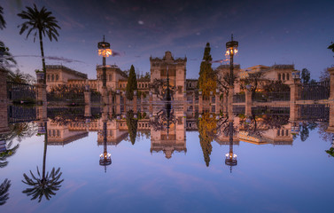 inverted reflection of a museum palace placed in a park in spain