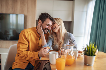 Romantic young couple having coffee together