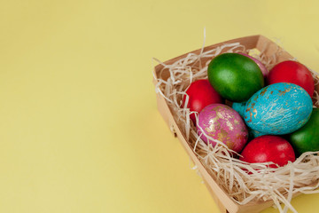 Happy Easter eggs yellow background. Golden shine decorated eggs in basket, for greeting card, promotion, poster. Copy space