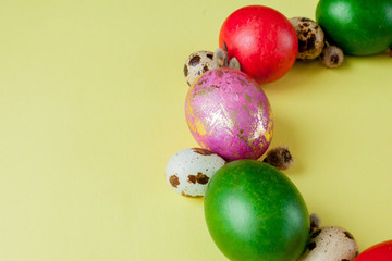 Top view painted eggs Easter Frame in circle shape on a yellow background. Copy space