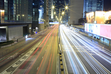 Fototapeta na wymiar busy vehicle movement -downtown buildings in hong kong highway