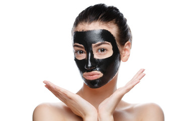 girl with black cosmetic mask on face posing