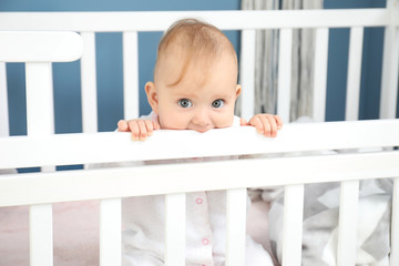 Cute baby sitting in crib