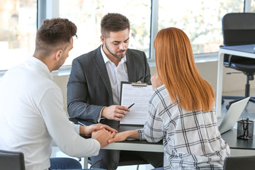 Bank manager working with clients in office