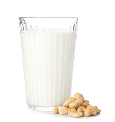 Glass of fresh cashew milk on white background