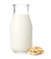 Bottle of fresh cashew milk on white background