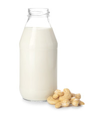 Bottle of fresh cashew milk on white background