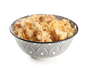 Bowl with tasty rice and chicken on white background