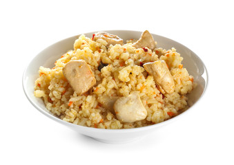 Bowl with tasty rice and chicken on white background