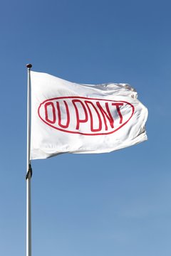 Aarhus, Denmark - May 16, 2016: Flag of the brand Du Pont. DuPont is one of America's most innovative companies and it is an American chemical company that was founded in July 1802 as a gunpowder mill
