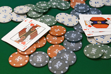 Chips and playing cards for gambling games on table in casino