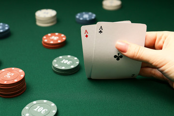 Woman playing poker in casino, closeup