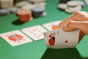 Man playing poker in casino, closeup