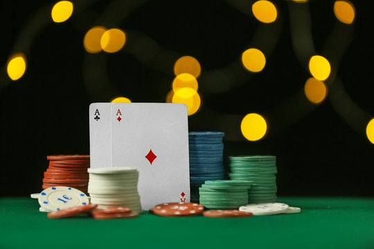 Chips and playing cards for gambling games on table in casino