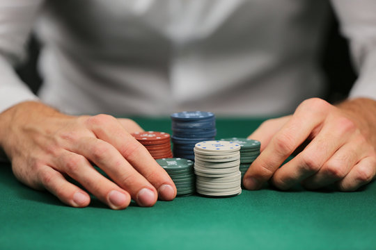 Man playing poker in casino, closeup