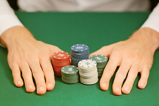 Man playing poker in casino, closeup