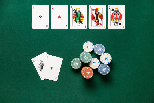 Chips and playing cards for gambling games on table in casino