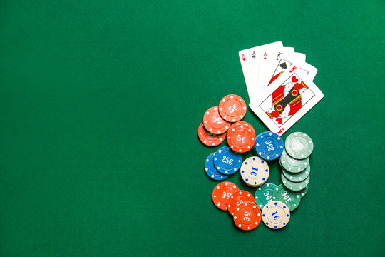 Chips and playing cards for gambling games on table in casino