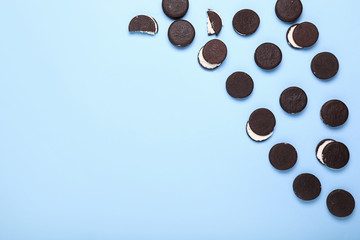 Tasty chocolate cookies on color background