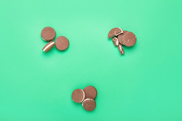 Tasty chocolate cookies on color background