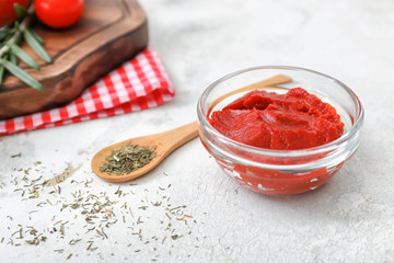 Bowl with tasty tomato sauce on white table