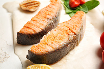 Tasty cooked salmon on table, closeup
