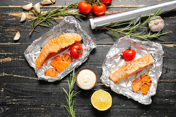 Tasty cooked salmon and vegetables on table